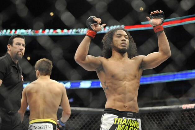 Jan 25, 2014; Chicago, IL, USA; Benson Henderson (red gloves) reacts after defeating Josh Thomson (blue gloves) during UFC on FOX 10 at the United Center. Mandatory Credit: David Banks-USA TODAY Sports
