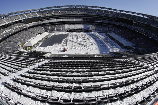 In this photograph taken with a fisheye lens, snow is accumulated on the seats and on the field of MetLife Stadium as crews removed snow ahead of Super Bowl XLVIII following a snow storm, Wednesday, Jan. 22, 2014, in East Rutherford, N.J. Super Bowl XLVIII, which will be played between the Denver Broncos and the Seattle Seahawks on Feb. 2, will be the first NFL title game held outdoors in a city where it snows. (AP Photo/Julio Cortez)