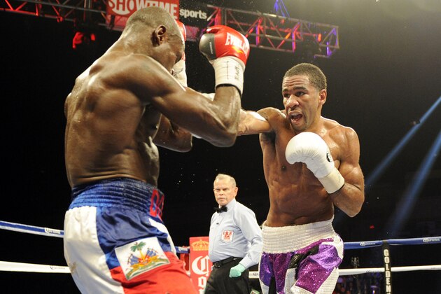 Lamont Peterson, right, punches Dierry Jean, of Canada, left, during the IBF Junior welterweight title boxing match, Saturday, Jan. 25, 2014, in Washington. Peterson won the match. (AP Photo/Nick Wass)
