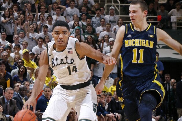 Michigan State's Gary Harris (14) gets a steal against Michigan's Nik Stauskas (11) during the second half of an NCAA college basketball game, Saturday, Jan. 25, 2014, in East Lansing, Mich. Michigan won 80-75. (AP Photo/Al Goldis)