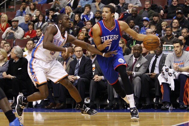 Philadelphia 76ers' Michael Carter-Williams, right, in action against Oklahoma City Thunder's Reggie Jackson, left, during the second half of an NBA basketball game, Saturday, Jan. 25, 2014, in Philadelphia. The Thunder won 103-91. (AP Photo/Chris Szagola)
