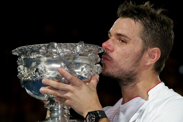 Stanislas Wawrinka of Switzerland kisses the trophy after defeating Rafael Nadal of Spainduring the men's singles final at the Australian Open tennis championship in Melbourne, Australia, Sunday, Jan. 26, 2014.(AP Photo/Aaron Favila)