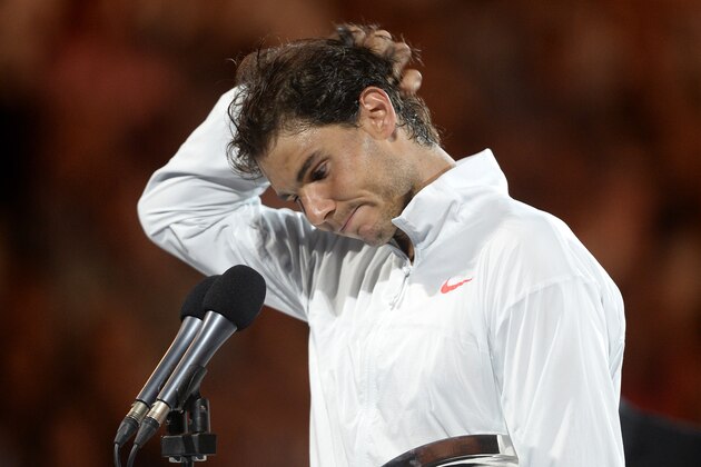 Rafael Nadal of Spain reacts as he speaks during the trophy presentation,  after his loss to Stanislas Wawrinka of Switzerland in the men's singles final at the Australian Open tennis championship in Melbourne, Australia, Sunday, Jan. 26, 2014.(AP Photo/Andrew Brownbill)