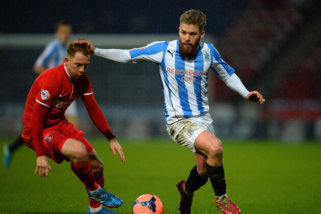 HUDDERSFIELD, ENGLAND - JANUARY 25: Danny Green of Charlton Athletic battles with Dale Stephens of Huddersfield during the Budweiser FA Cup Fourth Round  match between Huddersfield Town and Charlton Athletic at John Smith's Stadium on January 25, 2014 in Huddersfield, England.  (Photo by Laurence Griffiths/Getty Images)