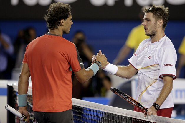 Stanislas Wawrinka of Switzerland, right,  shakes hands with Rafael Nadal of Spain at the net after Wawrinka won the men's singles final at the Australian Open tennis championship in Melbourne, Australia, Sunday, Jan. 26, 2014.(AP Photo/Rick Rycroft)