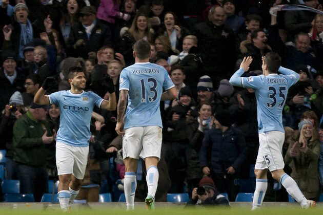 Manchester City's Sergio Aguero, left, celebrates with teammates after scoring the third of his 3 goals past Watford's goalkeeper Jonathan Bond during their English FA Cup fourth round soccer match at The City of Manchester Stadium, Manchester, England, Saturday, Jan. 25, 2014. (AP Photo/Jon Super)