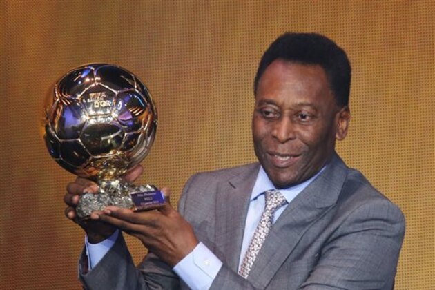 Brazil's soccer legend Pele displays the honorary prize he received at the FIFA Ballon d'Or 2013 Gala in Zurich, Switzerland, Monday, Jan. 13, 2014. (AP Photo/Michael Probst)