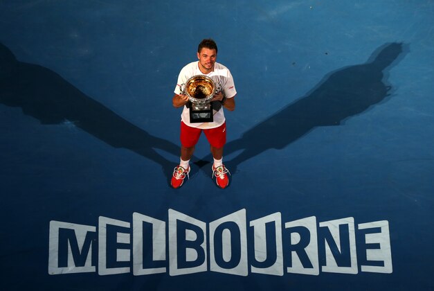 Stanislas Wawrinka of Switzerland holds the trophy after defeating Rafael Nadal of Spain in the men's singles final at the Australian Open tennis championship in Melbourne, Australia, Sunday, Jan. 26, 2014.(AP Photo/Eugene Hoshiko)