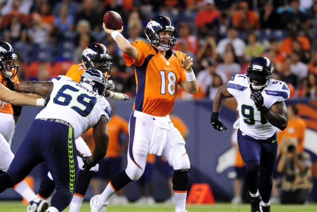 Aug 18, 2012; Denver, CO, USA;  Denver Broncos quarterback Peyton Manning (18) passes in the second quarter against the Seattle Seahawks at Sports Authority Field.  Mandatory Credit: Byron Hetzler-USA TODAY Sports