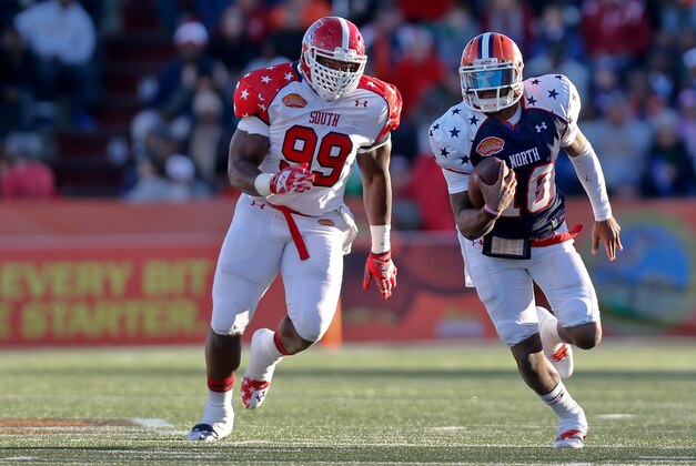 Jan 25, 2014; Mobile, AL, USA; North squad quarterback Tajh Boyd of Clemson (10) runs from South squad defensive end I.K. Enemkpali of Louisiana Tech (99) during the first half of a game at Ladd-Peebles Stadium. Mandatory Credit: Derick E. Hingle-USA TODAY Sports