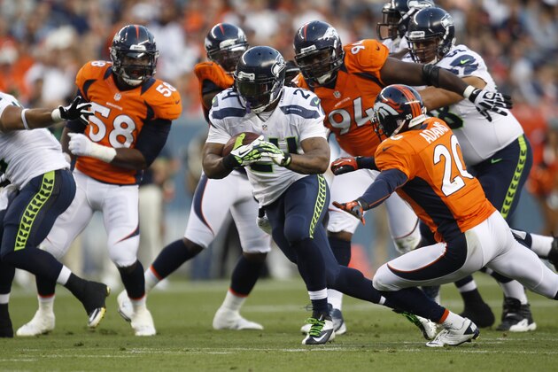 Seattle Seahawks runningback Marshawn Lynch, center, runs for yardage against the Denver Broncos in the first half of an NFL football preseason game, Saturday, Aug. 18, 2012, in Denver. (AP Photo/David Zalubowski)