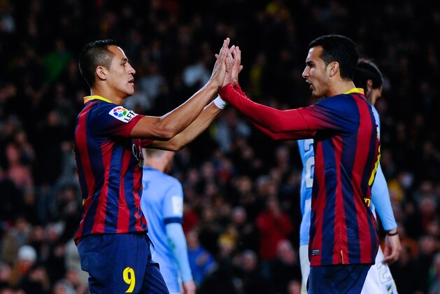 BARCELONA, SPAIN - JANUARY 26:  Alexis Sanchez (L) of FC Barcelona celebrates with his team mate Pedro Rodriguez after scoring his team's third goal during the La Liga match between FC Barcelona and Malaga CF at Camp Nou on January 26, 2014 in Barcelona, Spain.  (Photo by David Ramos/Getty Images)