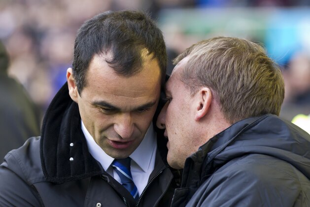 Liverpool's manager Brendan Rodgers, right, whispers to Everton's manager Roberto Martinez before their English Premier League soccer match at Goodison Park Stadium, Liverpool, England, Saturday Nov. 23, 2013. (AP Photo/Jon Super) Liverpool's manager Brendan Rodgers, right, whispers to Everton's manager Roberto Martinez before their English Premier League soccer match at Goodison Park Stadium, Liverpool, England, Saturday Nov. 23, 2013. (AP Photo/Jon Super)