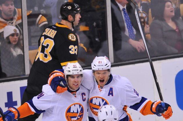 BOSTON, MA - DECEMBER 31:  John Tavares #91, Kyle Okposo #21 and Thomas Hickey #14 of the New York Islanders celebrate a goal against the Boston Bruins at the TD Garden on December 31, 2013 in Boston, Massachusetts.  (Photo by Steve Babineau/NHLI via Getty Images)