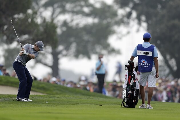Jordan Spieth, left, hits his second shot on the second hole of the South Course at Torrey Pines during the final round of the Farmers Insurance Open golf tournament Sunday, Jan. 26, 2014, in San Diego. (AP Photo/Gregory Bull)