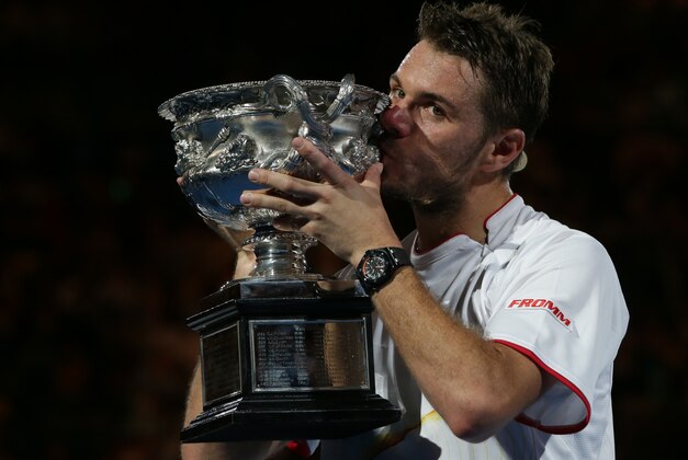 Stanislas Wawrinka of Switzerland kisses the trophy after defeating Rafael Nadal of Spain in the men's singles final at the Australian Open tennis championship in Melbourne, Australia, Sunday, Jan. 26, 2014. (AP Photo/Aaron Favila)