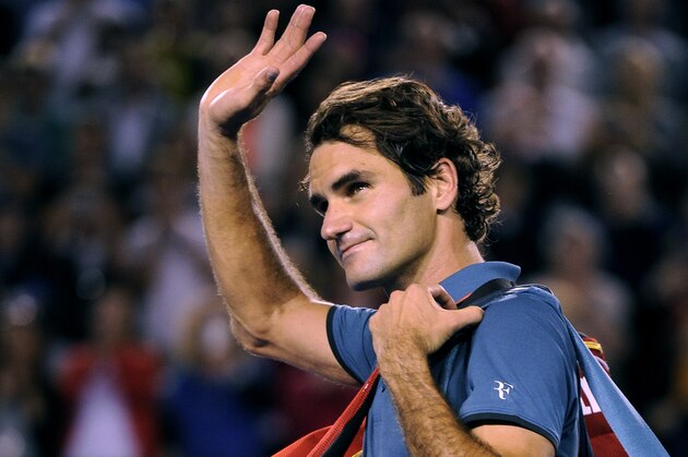 Roger Federer of  Switzerland walks off the Rod Laver Arena after his semifinal loss to Rafael Nadal of Spain during their semifinal at the Australian Open tennis championship in Melbourne, Australia, Friday, Jan. 24, 2014.(AP Photo/Andrew Brownbill)