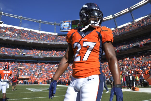 Denver Broncos running back Knowshon Moreno (27) walks across the field before the AFC Championship NFL playoff football game against the New England Patriots in Denver, Sunday, Jan. 19, 2014. (AP Photo/Jack Dempsey)