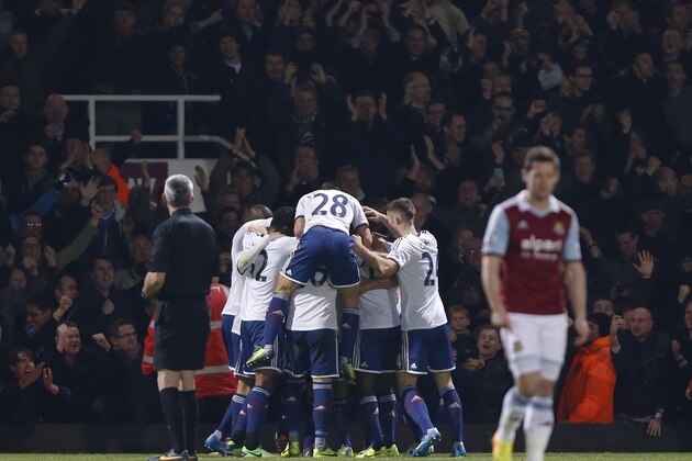 Chelsea's players celebrate Frank Lampard's goal against West Ham United during their English Premier League soccer match at Upton Park, London, Saturday, Nov. 23, 2013. (AP Photo/Sang Tan)