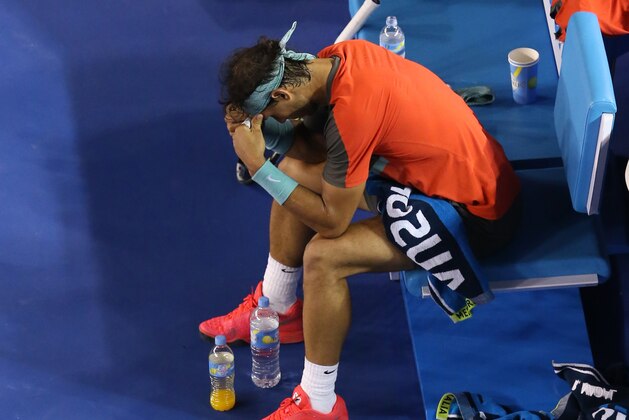 Rafael Nadal of Spain sits in a chair during a break in the men's singles final against Stanislas Wawrinka of Switzerland at the Australian Open tennis championship in Melbourne, Australia, Sunday, Jan. 26, 2014. (AP Photo/Eugene Hoshiko)