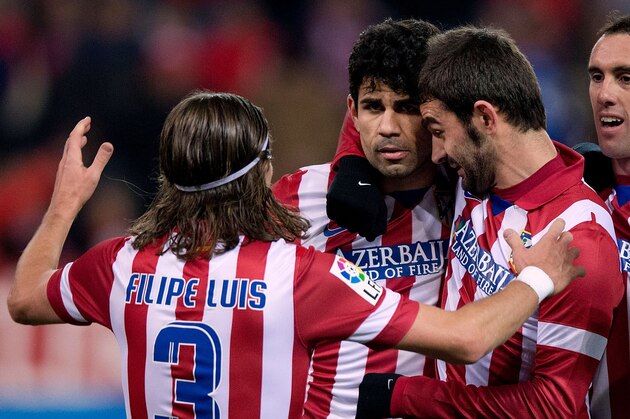 MADRID, SPAIN - DECEMBER 21:  Diego Costa (2ndL) of Atletico de Madrid celebrates scoring their second goal with teammates Filipe Luis (L), Diego Godin (R) and Adrian Lopez (2ndR) during the La Liga match between Club Atletico de Madrid and Levante UD at Vicente Calderon Stadium on December 21, 2013 in Madrid, Spain.  (Photo by Gonzalo Arroyo Moreno/Getty Images)