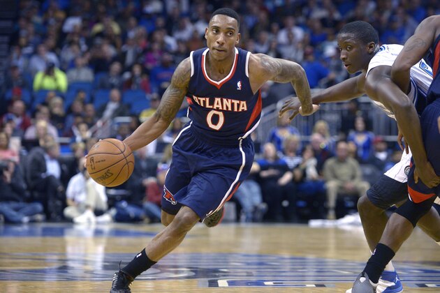 Atlanta Hawks point guard Jeff Teague (0) drives past Orlando Magic shooting guard Victor Oladipo, right, during the second half of an NBA basketball game in Orlando, Fla., Wednesday, Jan. 22, 2014. The Hawks won 112-109.(AP Photo/Phelan M. Ebenhack)
