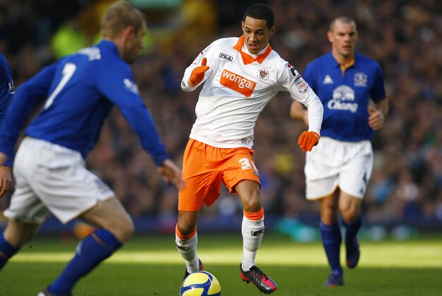 Everton's Tony Hibbert, left, vies for the ball against Blackpool's Thomas Ince during their English FA Cup fifth round soccer match at Goodison Park, Liverpool, England, Saturday Feb. 18, 2012. (AP Photo/Tim Hales)
