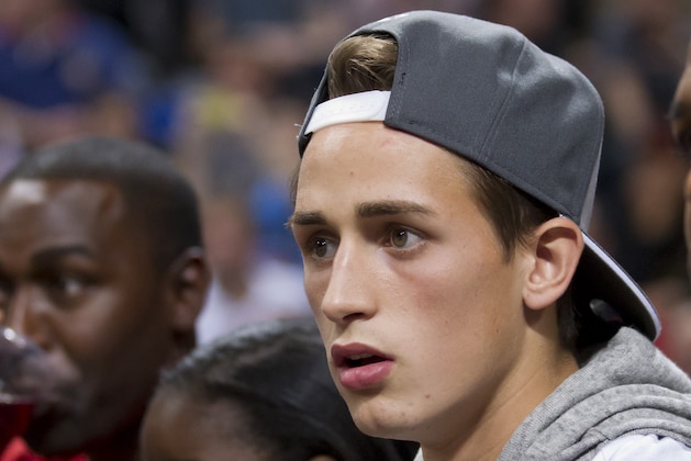 Manchester United's Adnan Januzaj, centre, sits between former players Andy Cole, left, and Quinton Fortune as Oklahoma City Thunder play the Philadelphia 76ers in a NBA preseason basketball game at the Phones 4u Arena in Manchester, England, Tuesday, Oct. 8, 2013. (AP Photo/Jon Super)