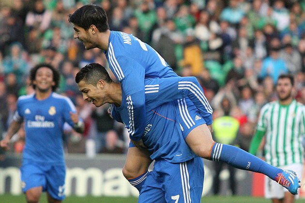 Real Madrid's Cristiano Ronaldo, bottom, celebrates with teammate Alvaro Morata after scoring against Betis during their La Liga soccer match at the Benito Villamarin stadium, in Seville, Spain on Saturday, Jan. 18, 2014. (AP Photo/Angel Fernandez)