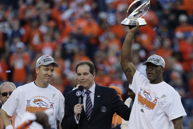 Denver Broncos quarterback Peyton Manning, left, and Denver Broncos wide receiver Demaryius Thomas, right, celebrate with the trophy after the AFC Championship NFL playoff football game against the New England Patriots in Denver, Sunday, Jan. 19, 2014. The Broncos defeated the Patriots 26-16 to advance to the Super Bowl. (AP Photo/Julie Jacobson)