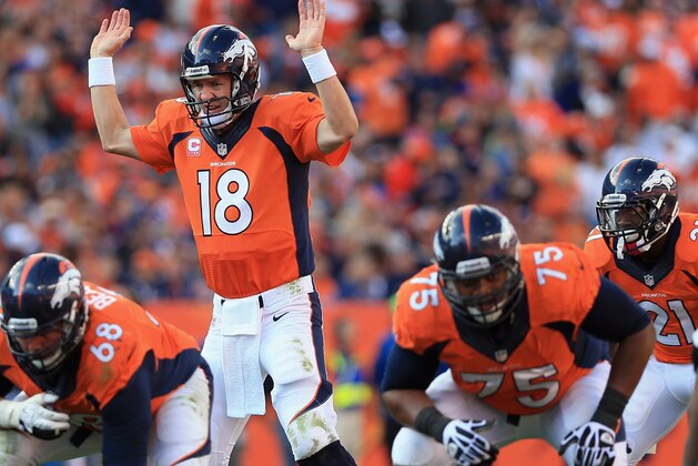 DENVER, CO - OCTOBER 13:  Quarterback Peyton Manning #18 of the Denver Broncos runs the offense as guard Zane Beadles #68 of the Denver Broncos and tackle Chris Clark #75 of the Denver Broncos prepare to protect the line of scrimmage against the Jacksonville Jaguars at Sports Authority Field at Mile High on October 13, 2013 in Denver, Colorado. The Broncos defeated the Jaguars 35-19.  (Photo by Doug Pensinger/Getty Images)