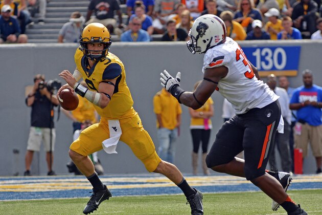 West Virginia quarterback Clint Trickett (9) avoids the pass rush in the third quarter of an NCAA college football game against Oklahoma State in Morgantown, W.Va., on Saturday, Sept. 28, 2013. (AP Photo/Tyler Evert) West Virginia quarterback Clint Trickett (9) avoids the pass rush in the third quarter of an NCAA college football game against Oklahoma State in Morgantown, W.Va., on Saturday, Sept. 28, 2013. (AP Photo/Tyler Evert)