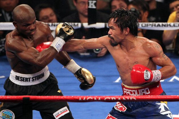 LAS VEGAS, NV - JUNE 09:  (R-L) Manny Pacquiao lands a right to the head of Timothy Bradley during their WBO welterweight title fight at MGM Grand Garden Arena on June 9, 2012 in Las Vegas, Nevada.  (Photo by Jeff Bottari/Getty Images)