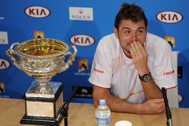 Stanislas Wawrinka of Switzerland speaks next to the trophy,  during a press conference after defeating Rafael Nadal of Spain in the men's singles final at the Australian Open tennis championship in Melbourne, Australia, Sunday, Jan. 26, 2014.(AP Photo/Andrew Brownbill)