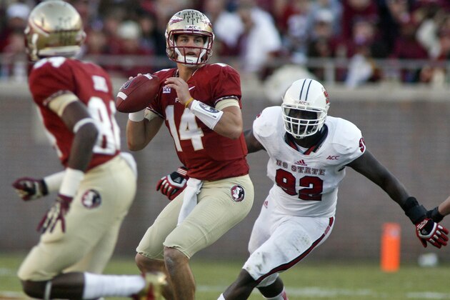Florida State quarterback Jacob Coker (14) looks for a receiver before being sacked by North Carolina State defensive end Darryl Cato-Bishop (92) in the third quarter of an NCAA college football game on Saturday, Oct. 26, 2013, in Tallahassee, Fla. Florida State won 49-17. (AP Photo/Phil Sears)