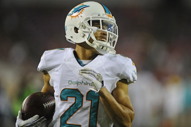 Miami Dolphins cornerback Brent Grimes (21) warms up before the start of an NFL football game against the Tampa Bay Buccaneers Monday, Nov. 11, 2013, in Tampa, Fla. (AP Photo/Brian Blanco)