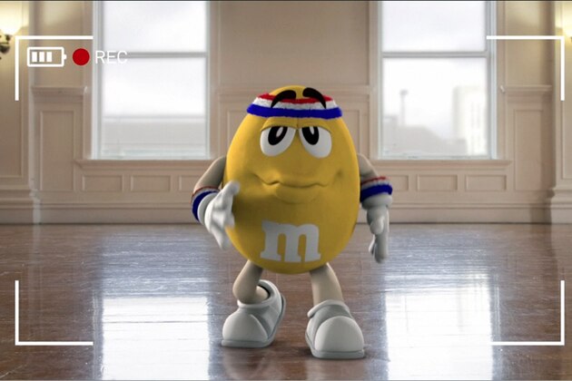 This image provided by Mars Inc. shows an online teaser ad for M&M's Super Bowl ad featuring its yellow peanut M&M “spokescandy”. The teaser is part of a Super Bowl ad trend: More content is being released ahead of time online in the hope that it goes viral. Advertisers are seeking to drum up excitement for their spots running during the big game, when more than 108 million people are expected to watching Feb. 2. (AP Photo/Mars Inc.)