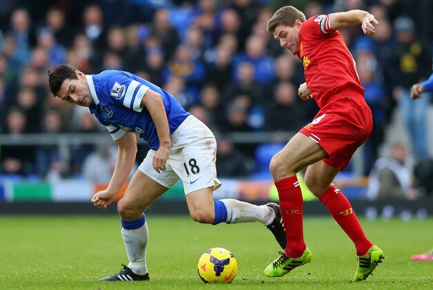 LIVERPOOL, ENGLAND - NOVEMBER 23:  Steven Gerrard of Liverpool tangles with Gareth Barry of Everton during the Barclays Premier League match between Everton and Liverpool at Goodison Park on November 23, 2013 in Liverpool, England.  (Photo by Alex Livesey/Getty Images)