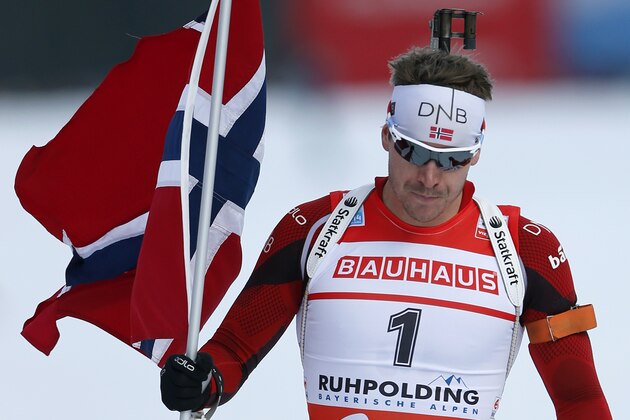 Norway's Emil Hegle Svendsen celebrates as he crosses the finish line to win the men's Pursuit 12.5 km competition at the Biathlon World Cup in Ruhpolding, Germany, Sunday, Jan, 12, 2014. (AP Photo/Matthias Schrader)
