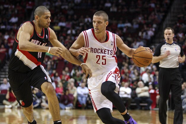 Jan 20, 2014; Houston, TX, USA; Houston Rockets small forward Chandler Parsons (25) drives during the second quarter as Portland Trail Blazers small forward Nicolas Batum (88) defends at Toyota Center. Mandatory Credit: Troy Taormina-USA TODAY Sports