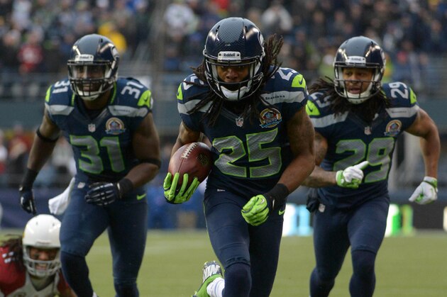Dec 9, 2012; Seattle, WA, USA; Seattle Seahawks cornerback Richard Sherman  (25) is accompanied by safety Kim Chancellor (31) and free safety Earl Thomas (31) on a 19-yard interception return for a touchdown against the Arizona Cardinals at CenturyLink Field. Mandatory Credit: Kirby Lee/Image of Sport-USA TODAY Sports