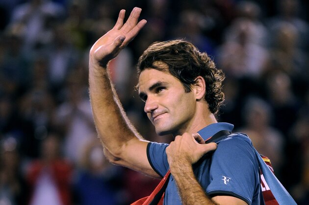 Roger Federer of  Switzerland walks off the Rod Laver Arena after his semifinal loss to Rafael Nadal of Spain during their semifinal at the Australian Open tennis championship in Melbourne, Australia, Friday, Jan. 24, 2014.(AP Photo/Andrew Brownbill)