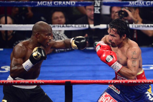 Jun. 9, 2012; Las Vegas, NV, USA; Timothy Bradley Jr (left) against Manny Pacquiao during a welterweight championship bout at the MGM Grand Garden Arena. Mandatory Credit: Mark J. Rebilas-USA TODAY Sports