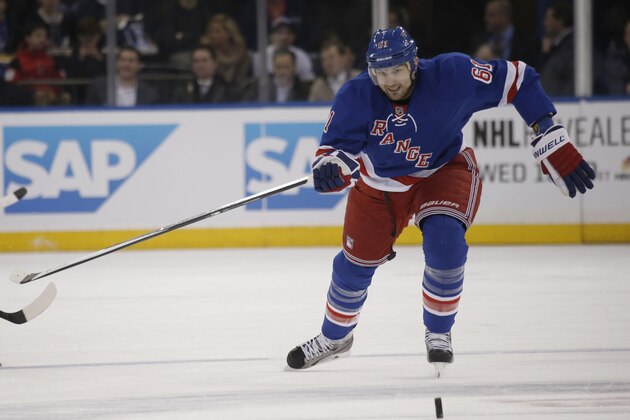New York Rangers left wing Rick Nash (61) goes after a loose puck in the first period of their NHL hockey game at Madison Square Garden in New York, Thursday, Jan. 23, 2014.  (AP Photo/Kathy Willens)