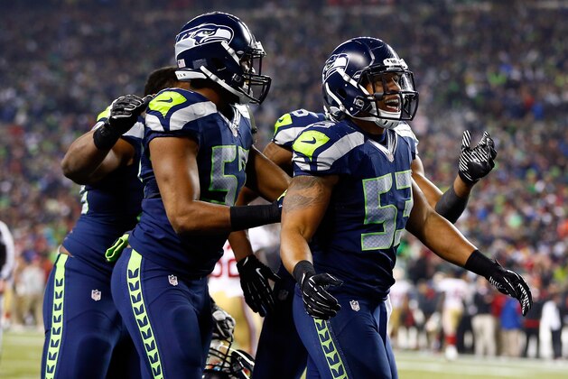 SEATTLE, WA - JANUARY 19:  Outside linebacker Malcolm Smith #53 and defensive back DeShawn Shead #35 celebrate after Smith intercepts a pass in the endzone to win the game for the Seahawks against the San Francisco 49ers during the 2014 NFC Championship at CenturyLink Field on January 19, 2014 in Seattle, Washington.  (Photo by Jonathan Ferrey/Getty Images)