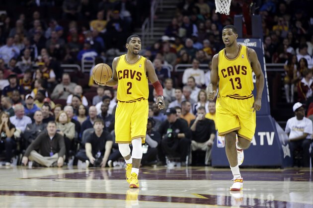 Cleveland Cavaliers' Kyrie Irving (2) calls a play as Tristan Thompson (13) trails in an NBA basketball game against the New Orleans Hornets Wednesday, Feb. 20, 2013, in Cleveland. (AP Photo/Mark Duncan)