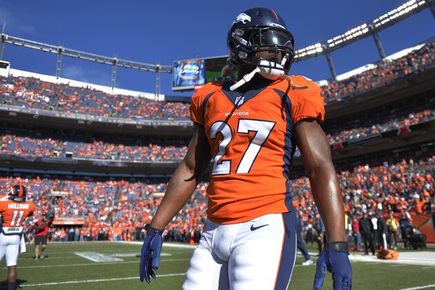 Denver Broncos running back Knowshon Moreno (27) walks across the field before the AFC Championship NFL playoff football game against the New England Patriots in Denver, Sunday, Jan. 19, 2014. (AP Photo/Jack Dempsey)