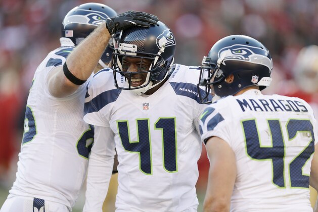 Seattle Seahawks' Byron Maxwell (41) is greeted by teammates, including Chris Maragos, right, after Maxwell intercepted a pass in the second half of an NFL football game against the San Francisco 49ers, Sunday, Dec. 8, 2013, in San Francisco. (AP Photo/Ben Margot)