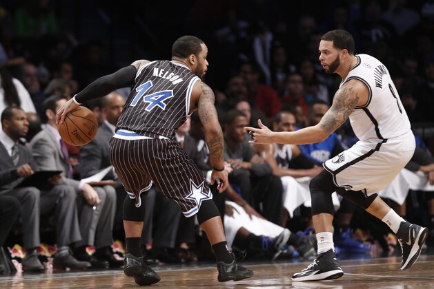 Brooklyn Nets guard Deron Williams (8) defends Orlando Magic guard Jameer Nelson (14) in the first half of their NBA basketball game at the Barclays Center, Tuesday, Jan. 21, 2014 in New York. (AP Photo/Kathy Willens)