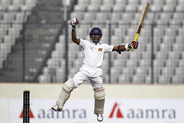 Sri Lanka’s Kaushal Silva jumps as he celebrates after scoring a century on the second day of the first test cricket match against Bangladesh in Dhaka, Bangladesh, Tuesday, Jan. 28, 2014. (AP Photo/A.M. Ahad)